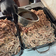 Load image into Gallery viewer, Pulled Pork being finished with natural jus poured back in
